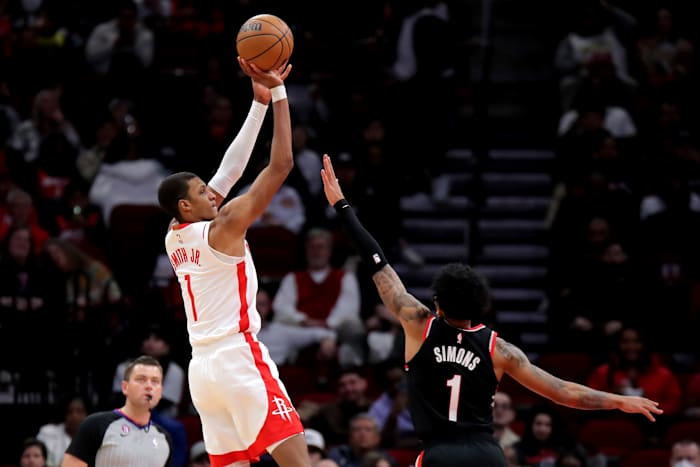 Rockets forward Jabari Smith Jr. (1) and Portland Trail Blazers guard Anfernee Simons (1) during the game at Toyota Center.